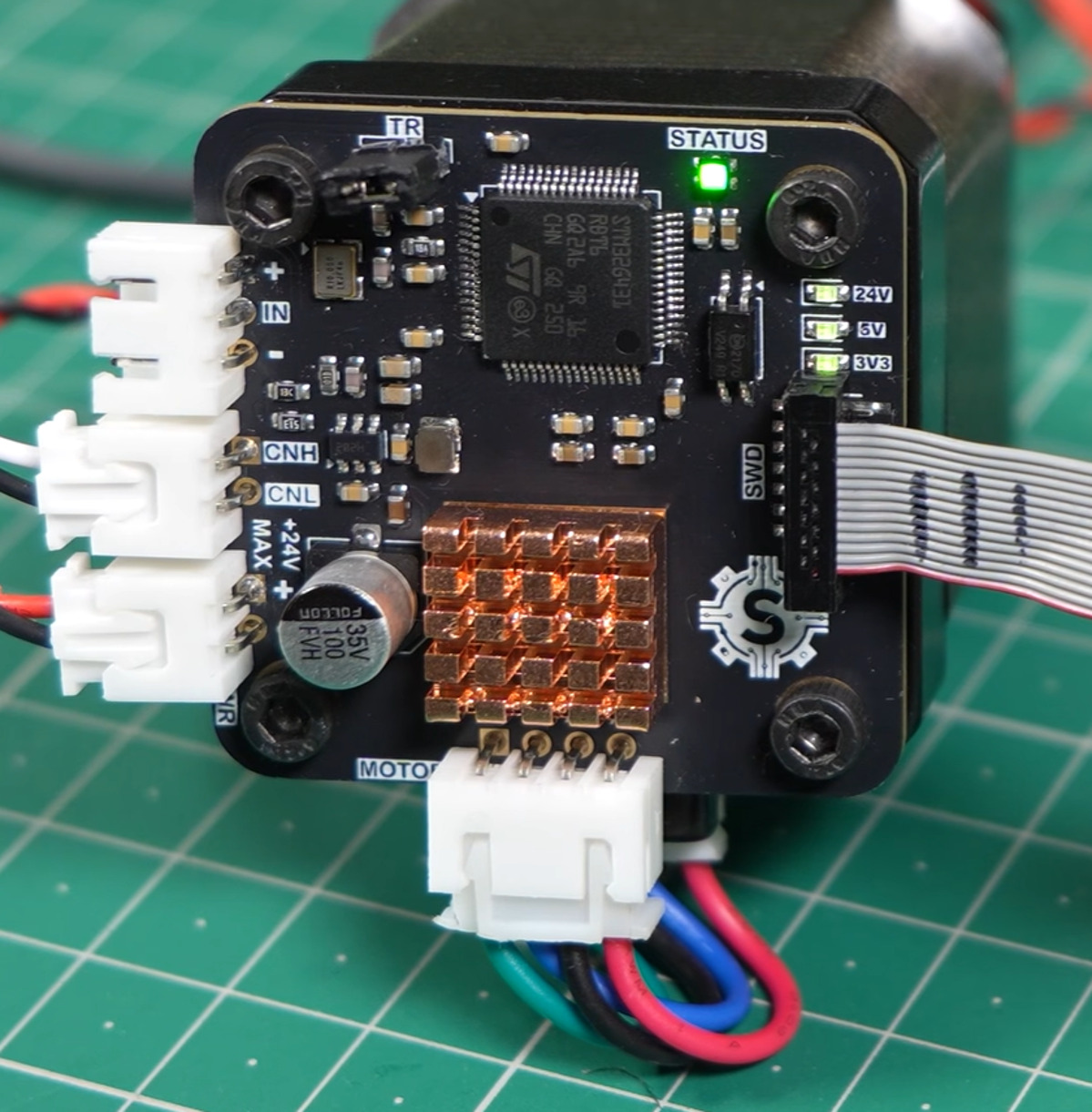 One of the custom stepper driver boards, mounted on the back of its motor