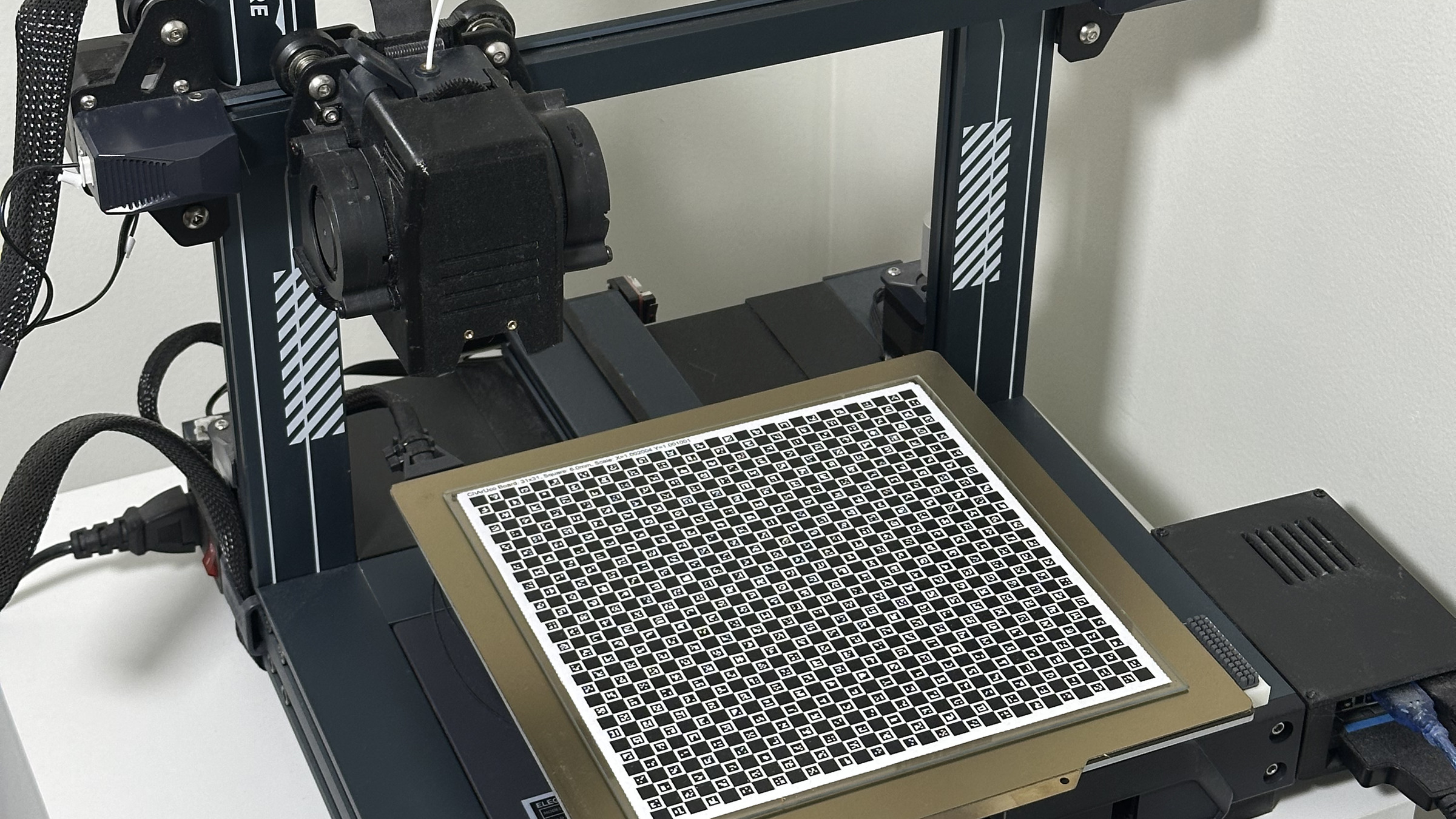 The printer with the ChArUco calibration board on its bed