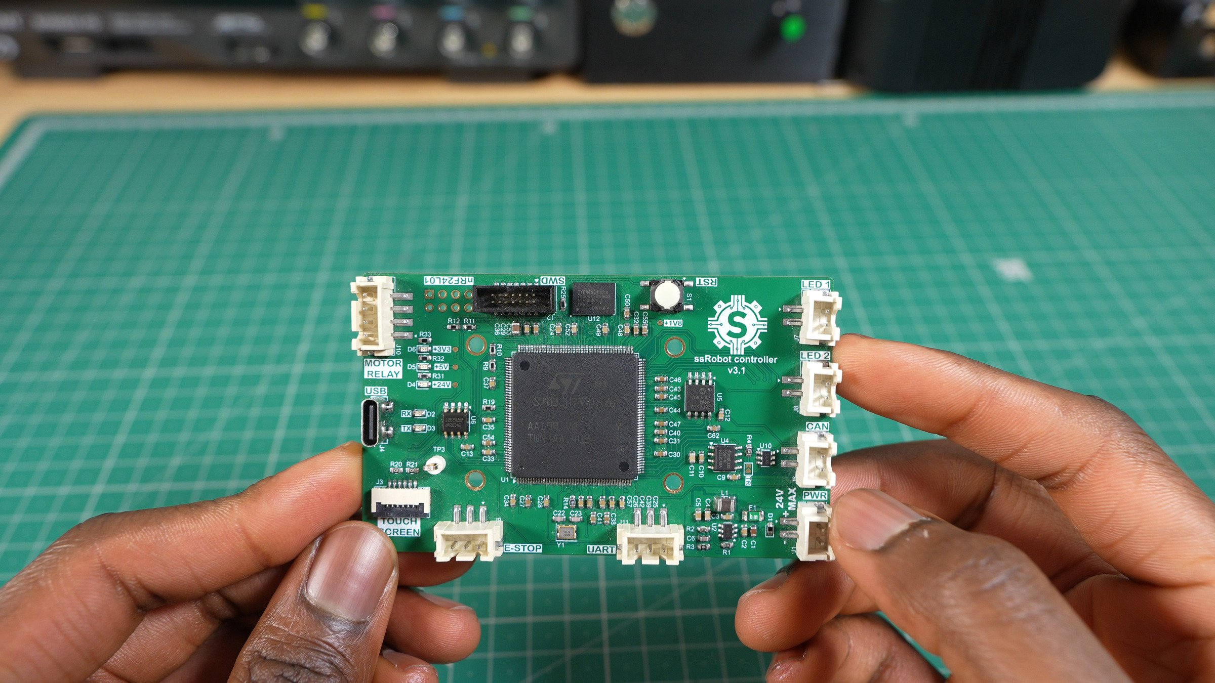 The ssRobot controller v3.1 main controller board, held up over a cutting mat